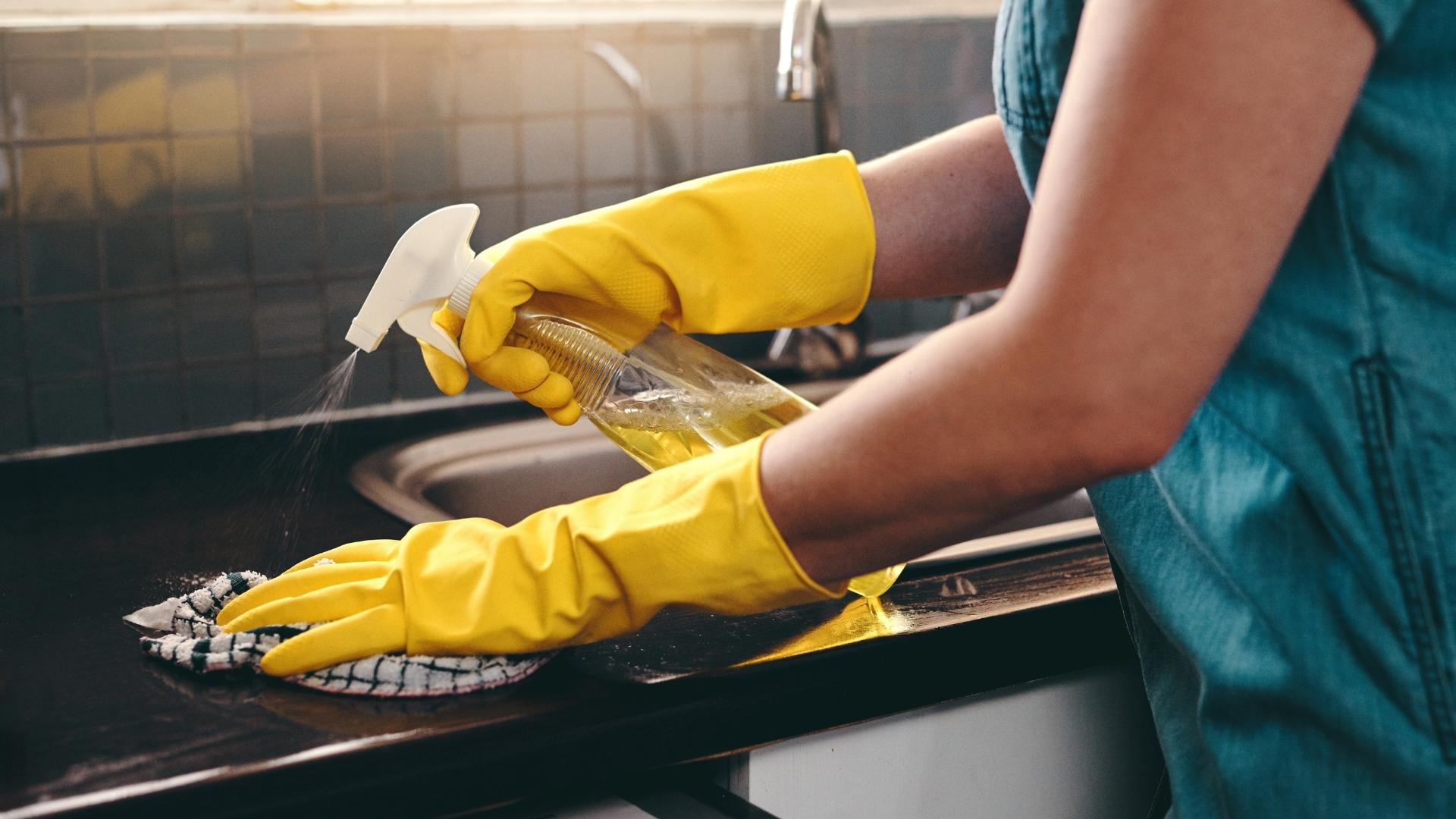 A cleaner meticulously sanitizing a bathroom during a deep cleaning service in Gatlinburg.